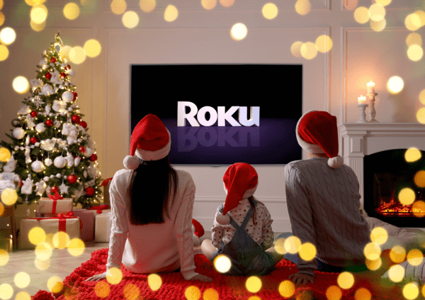 Family watching a Roku television in a holiday setting