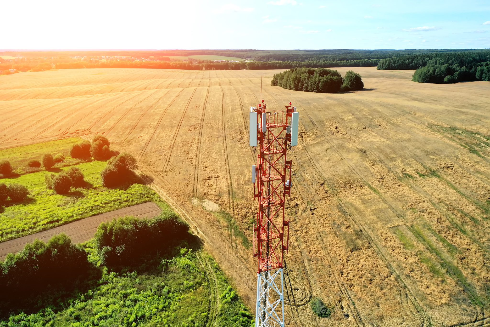 Aerial view of mobile phone cell tower over forested rural area